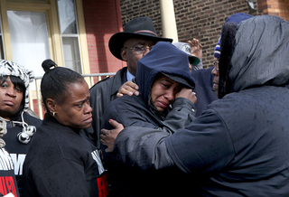 Janet Cooksey, center, the mother of Quintonio LeGrier, during a press conference on Dec. 27, 2015, to speak out about the shooting death of her son by the Chicago police. (Getty Images)
